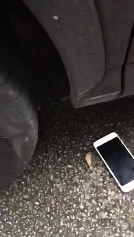 Hand and iPhone under wheel