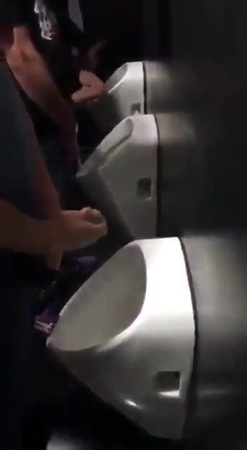 Three guys wanking at urinal