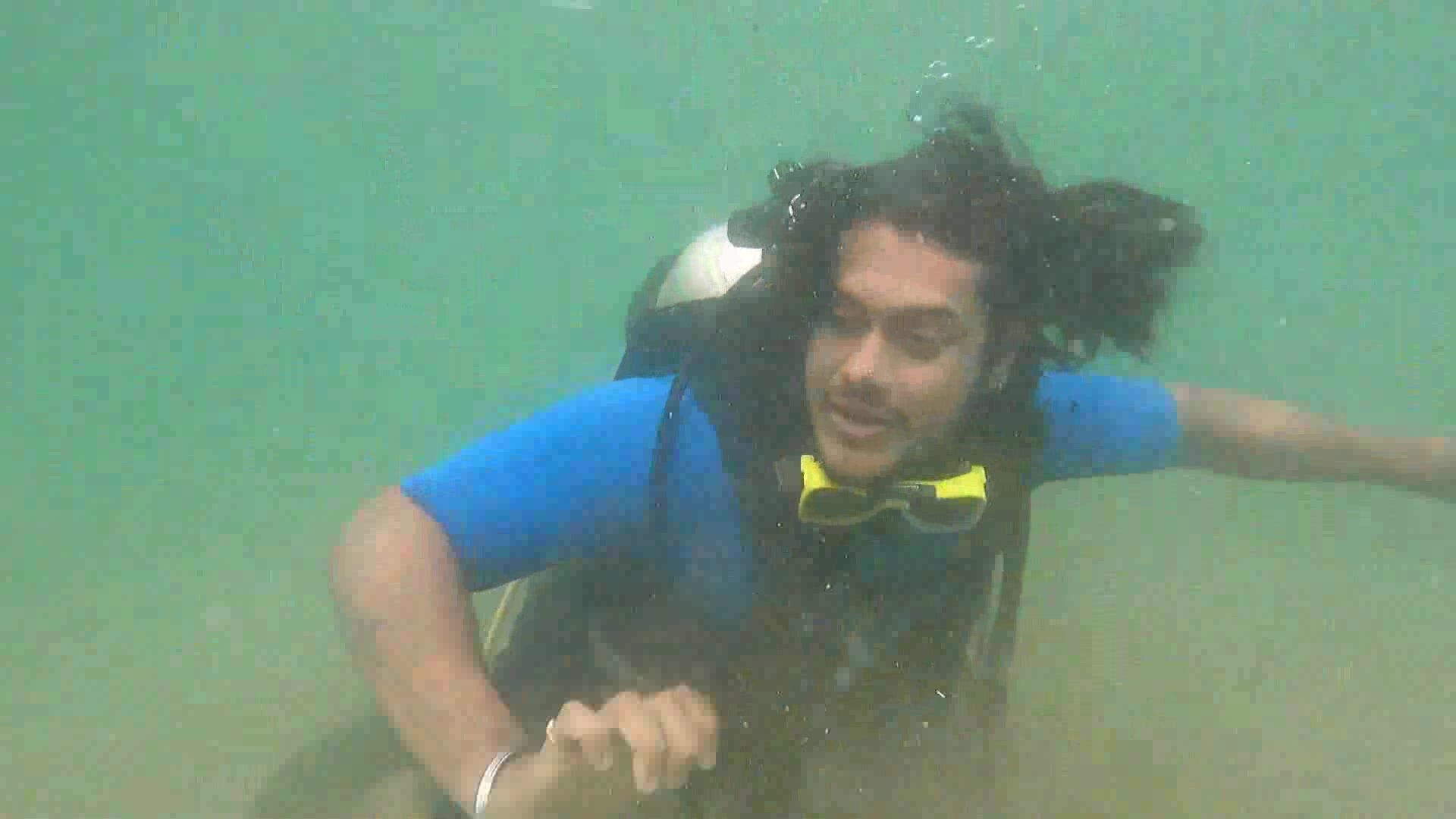Long haired scubadiver barefaced underwater