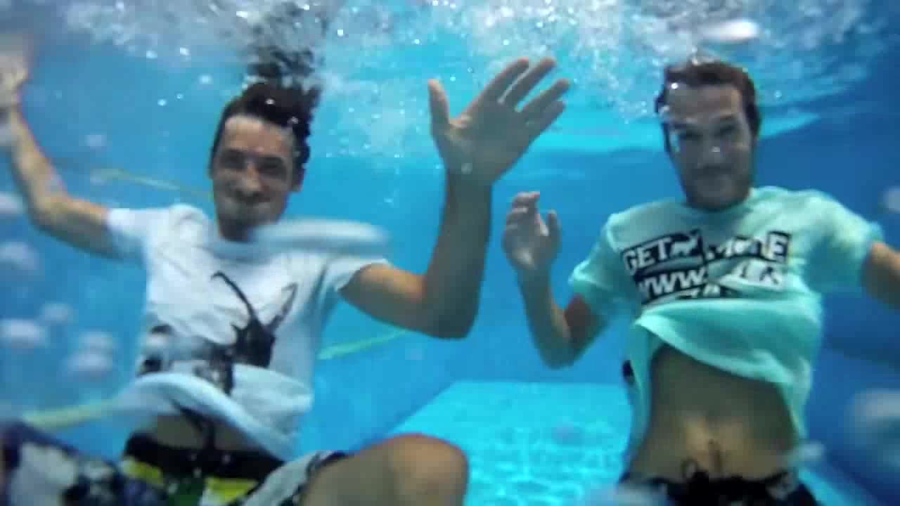 Underwater barefaced clothed buddies in pool