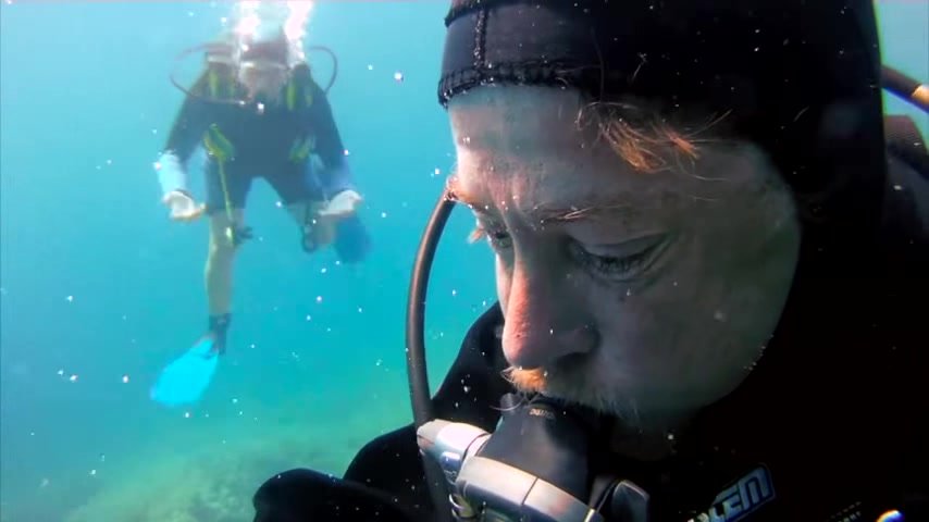 German scubadiver underwater mask removal in sea
