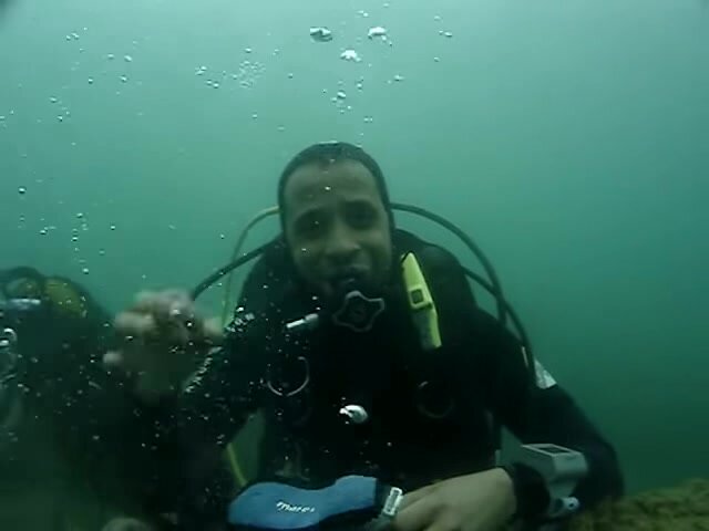 Arab scubadiver unmasking underwater