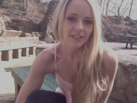 Gorgeous blonde chick uses a toy in the park