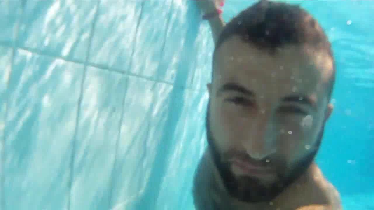 Bearded guy barefaced underwater in pool