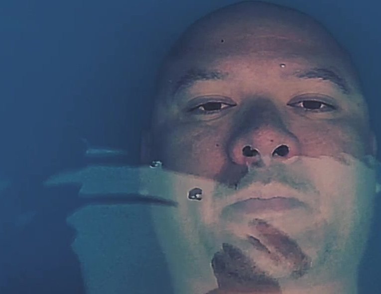 Bald guy breatholds barefaced underwater