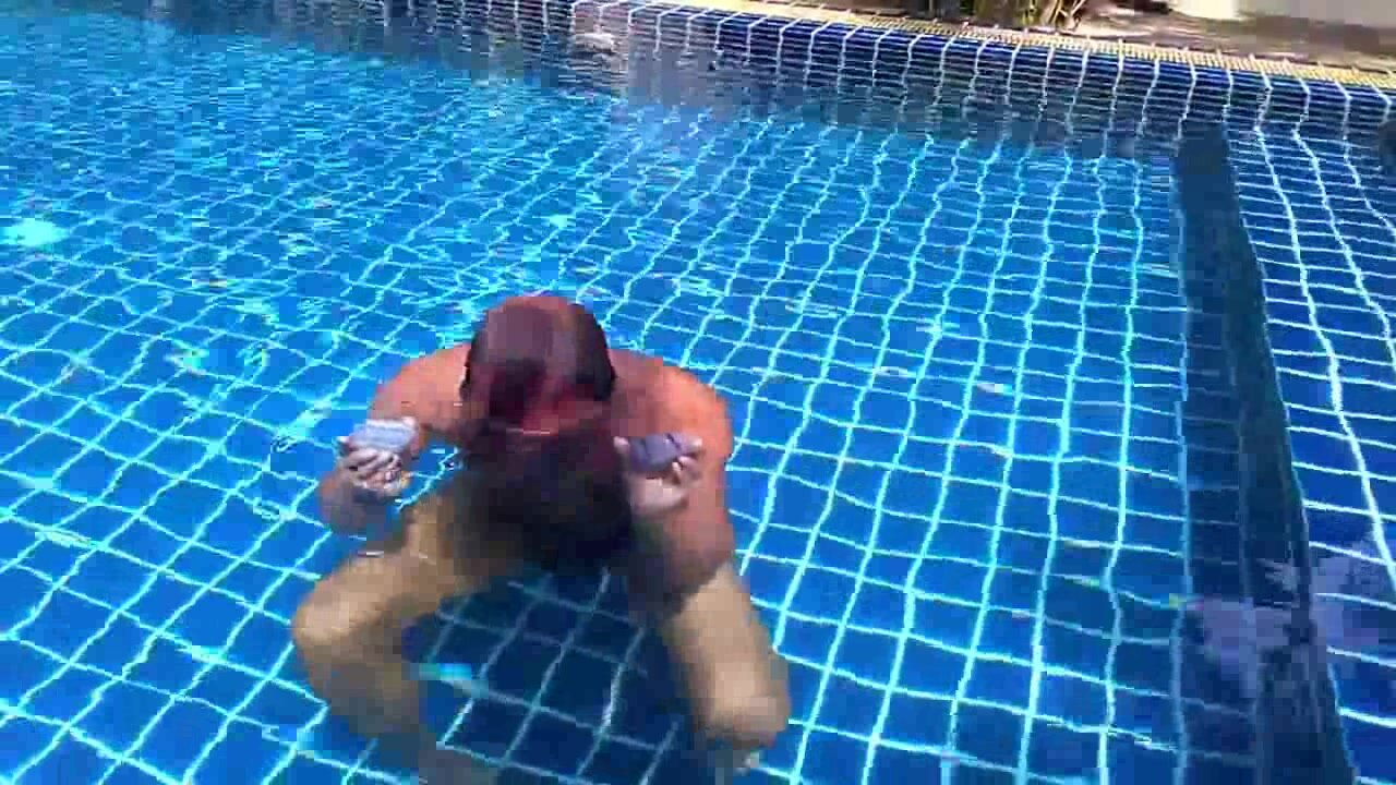 Underwater barefaced mature guy in speedo