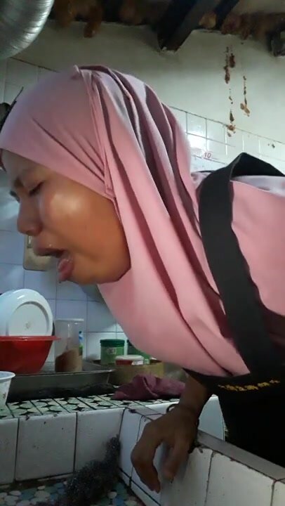HIjabi woman burps, spits, and vomits into sink.