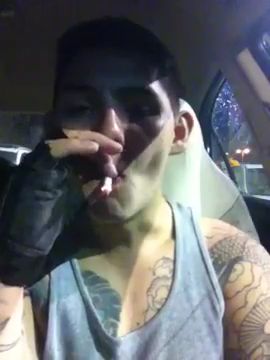 Young bodybuilder smoking in car