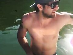 Hot guy pees himself off the boat