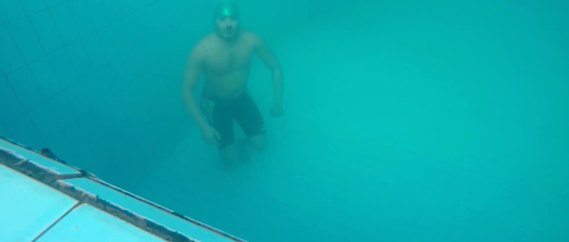 Kareem barefaced underwater with a friend