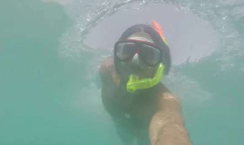 Blue speedo guy freediving in sea