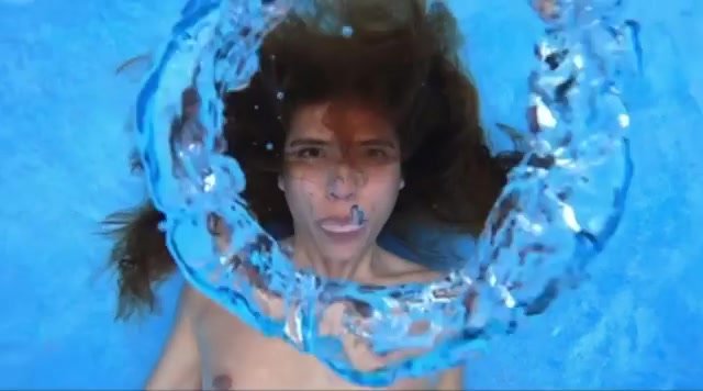 Merman blowing air rings underwater