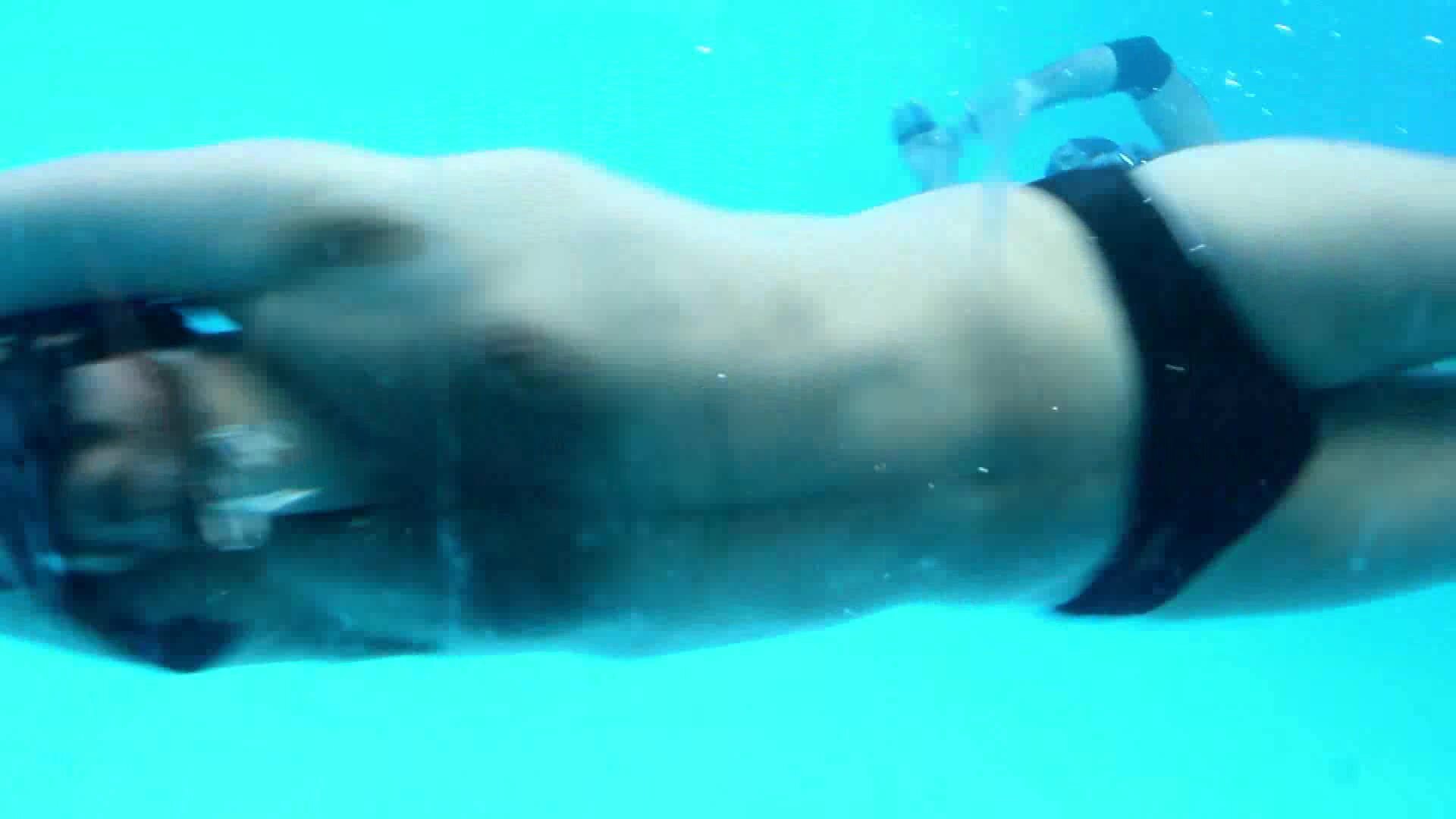 Underwater rugby players in bulging speedos