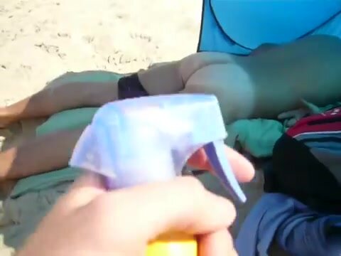 Sleeping guys ass get sprayed on beach