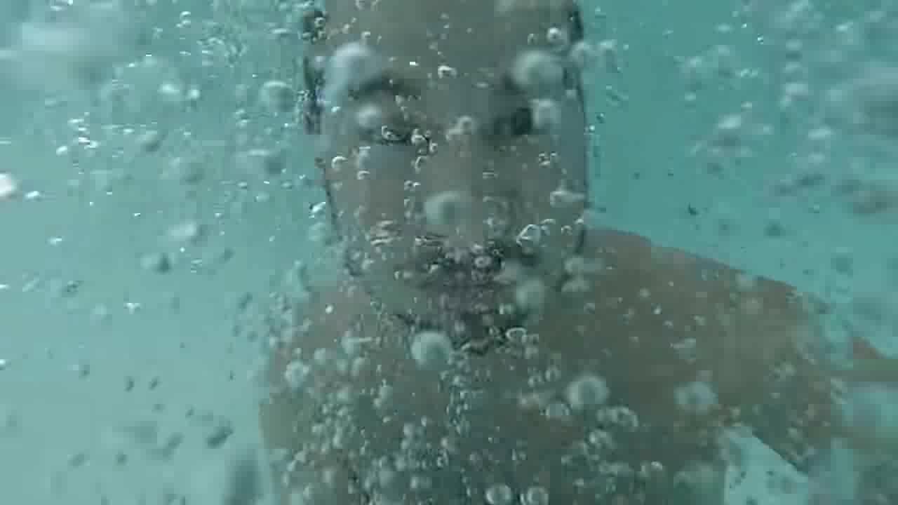 Bearded guy barefaced underwater in his pool