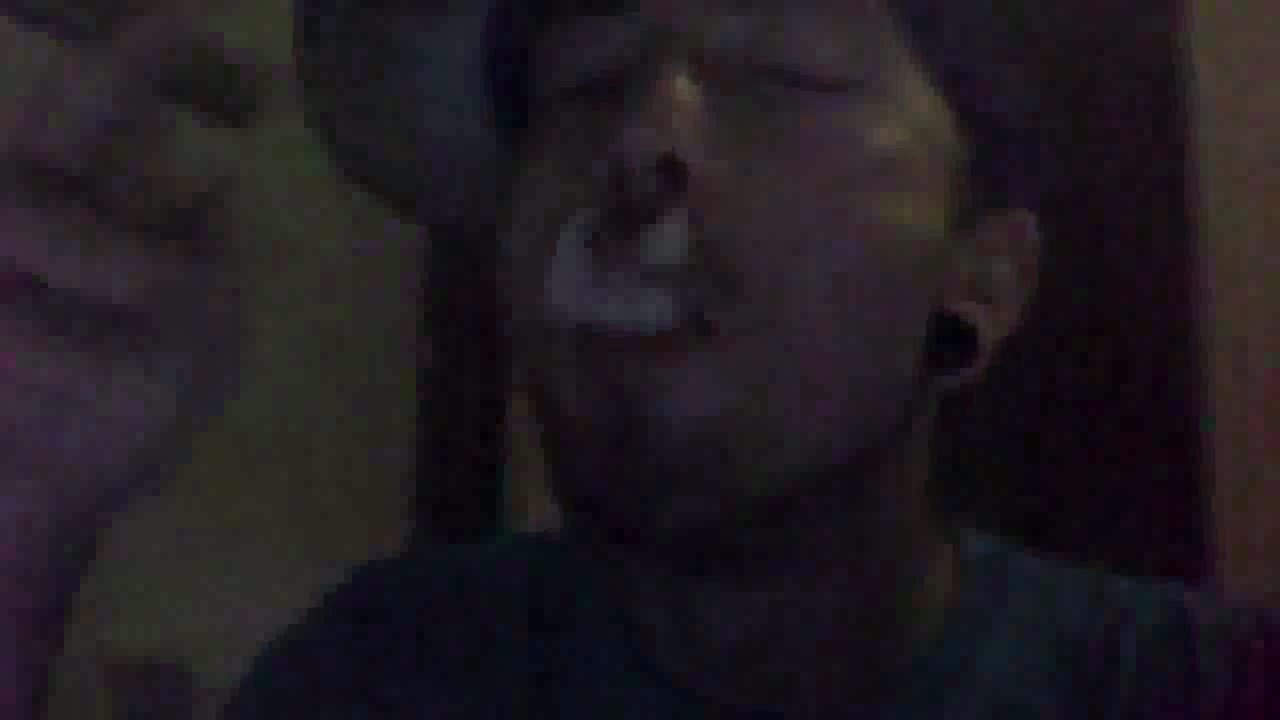 Upclose smoking with young cigar man