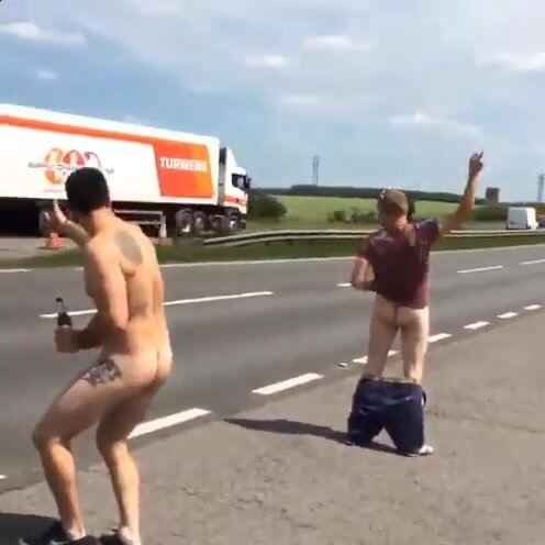 Two drunk guys flashing the traffic on a freeway