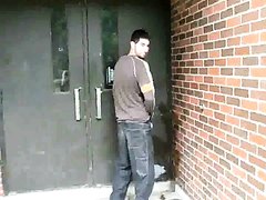guy pisses up wall