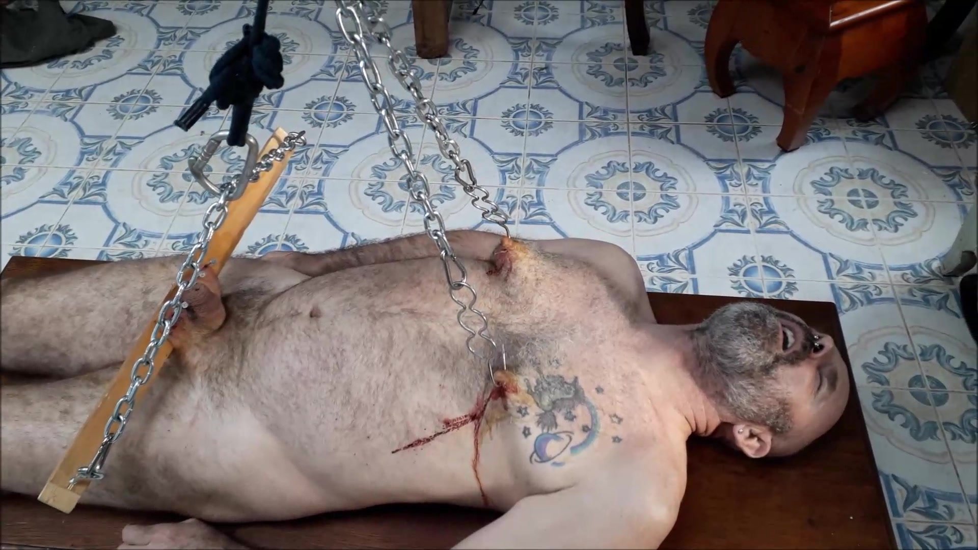 Slave is suspended by nipples and scrotum and tortured with electricity