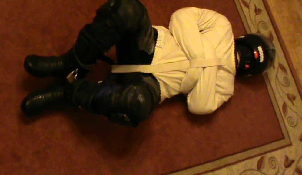 Blue and Black - leather bikerslave is straitjacketed