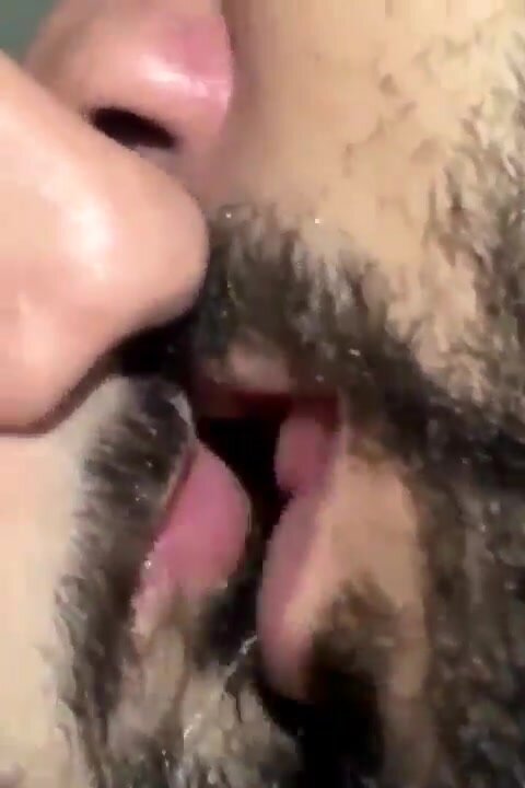 Bearded men tongue kissing