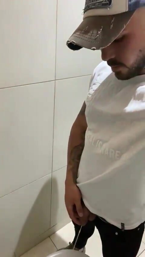 Cocky alpha pisses in a toilet