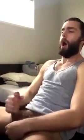 Bearded guy shoots cum over his head (short clip)