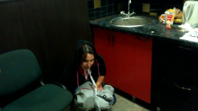 Coed girl pees in the corner of the room