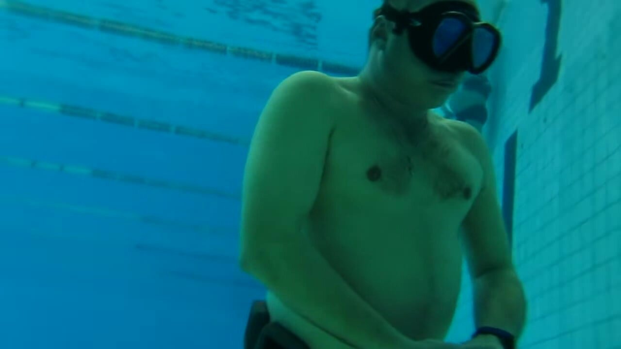 Beefy russian guy walking underwater