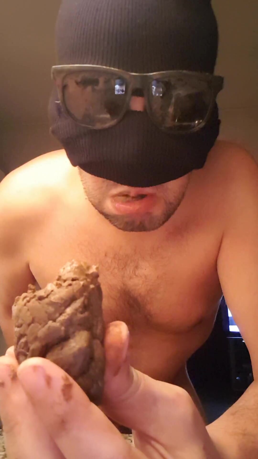 masked guy eats a turd