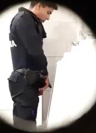 Policeman spying on his big cocked colleague pissing
