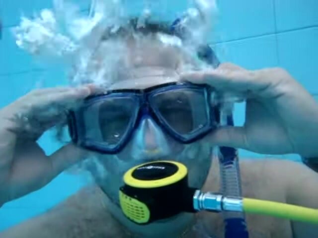 Beefy freedivers underwater in pool