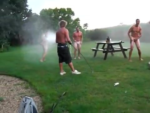 Naked Guys Being Hosed Down in Backyard After Paintball
