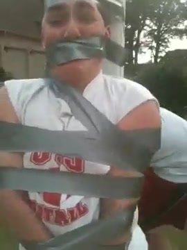 guy taped to pole and gagged