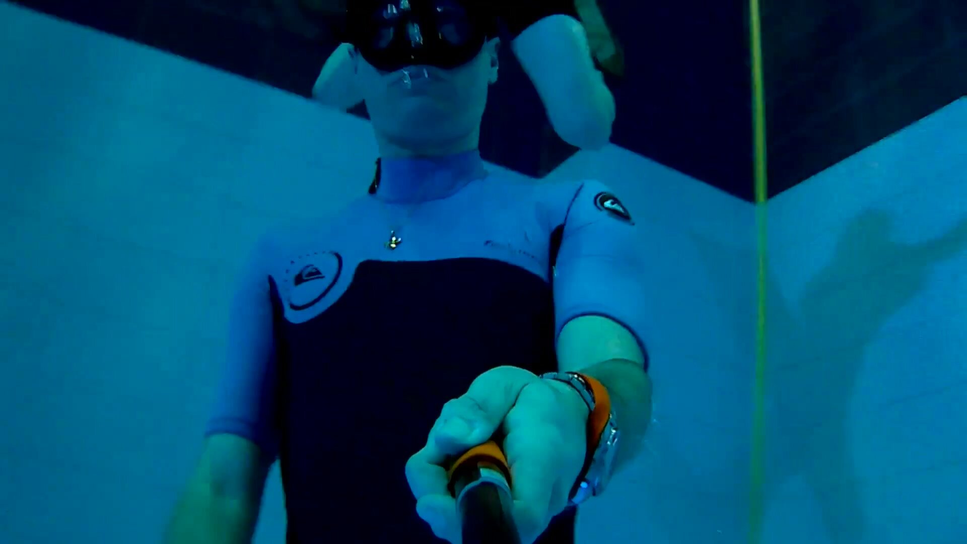 Freediving underwater in tight wetsuit