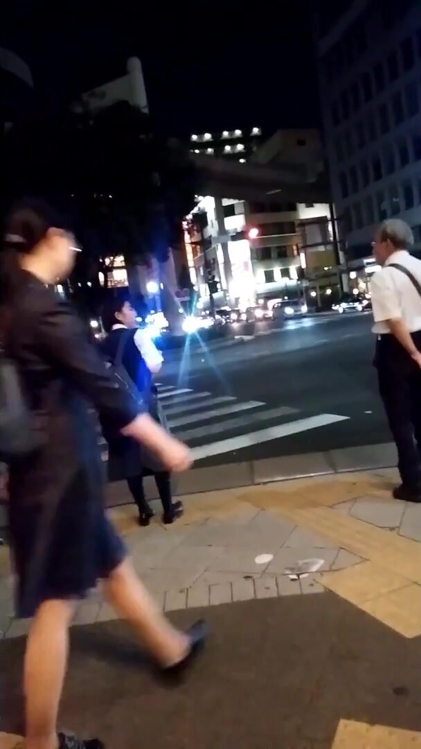 Japanese girl pee dancing at traffic light