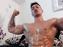 Sexy hunk flexing muscle with oil