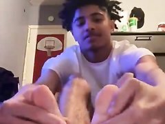 Young guy shows his bare feet
