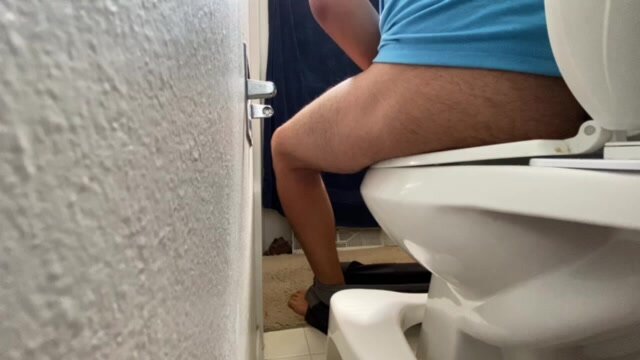 Poo on toilet with tight shorts