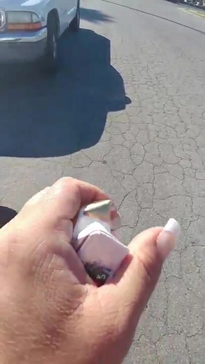 Girl littering her empty cigarette pack