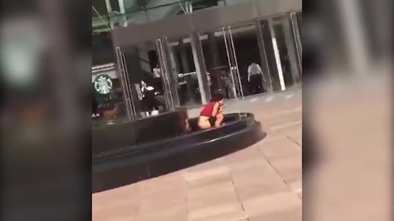 Chinese woman pissing in a public fountain
