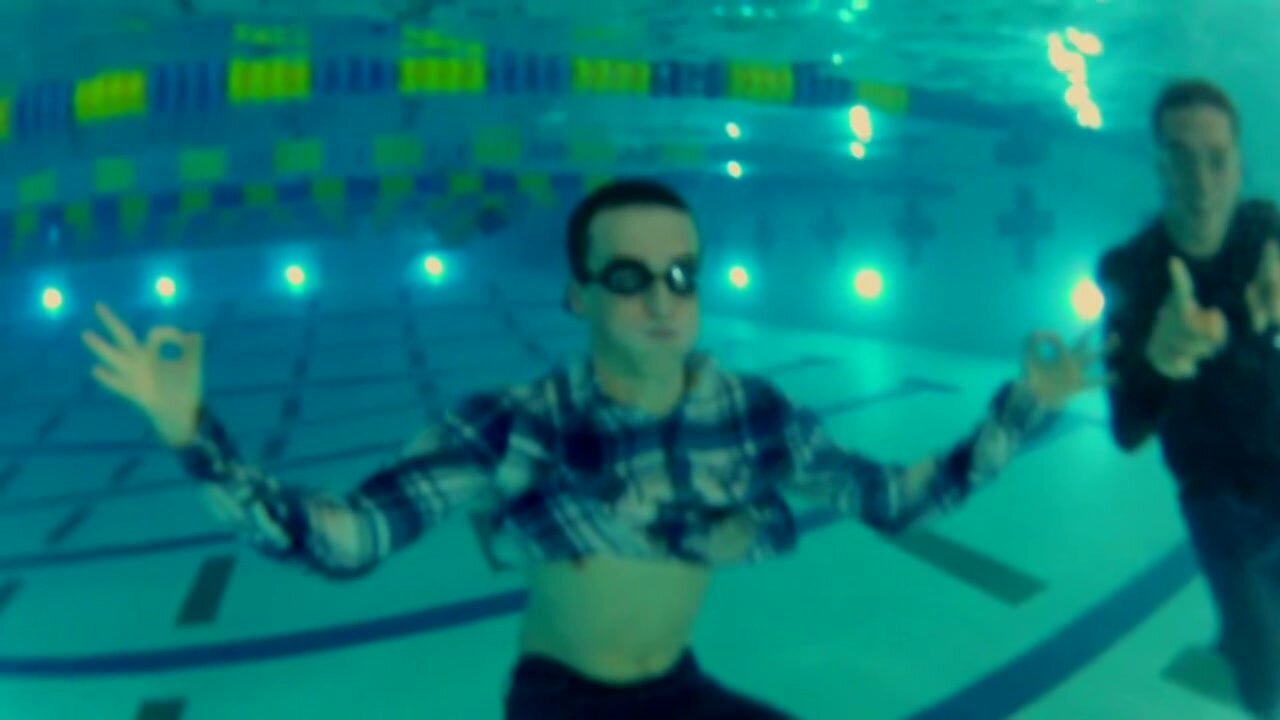 Swimming clothed underwater in pool