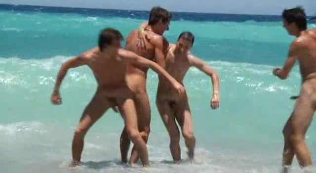 Group of Naked Guys Having Fun with the Incoming Tide