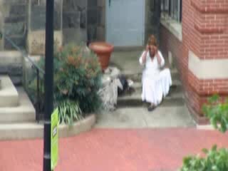 Lady pees on church porch