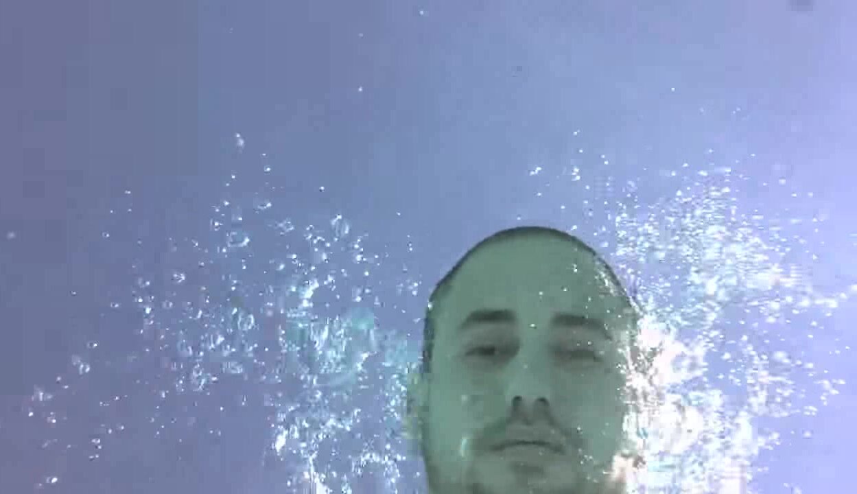 Barefaced guy breatholding underwater in pool - video 2