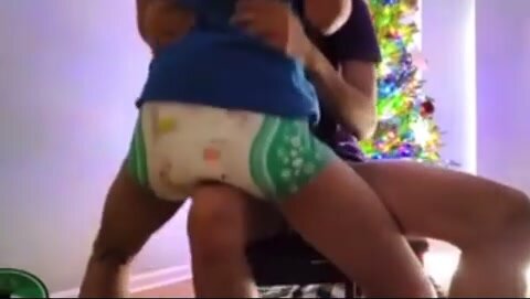 Forced to bounce messy diaper on knee