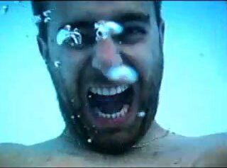 Underwater barefaced bearded man