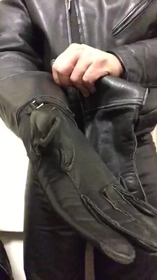 Pulling on a pair of ex police Gauntlet gloves.