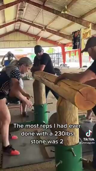 Girl pees while lifting rock