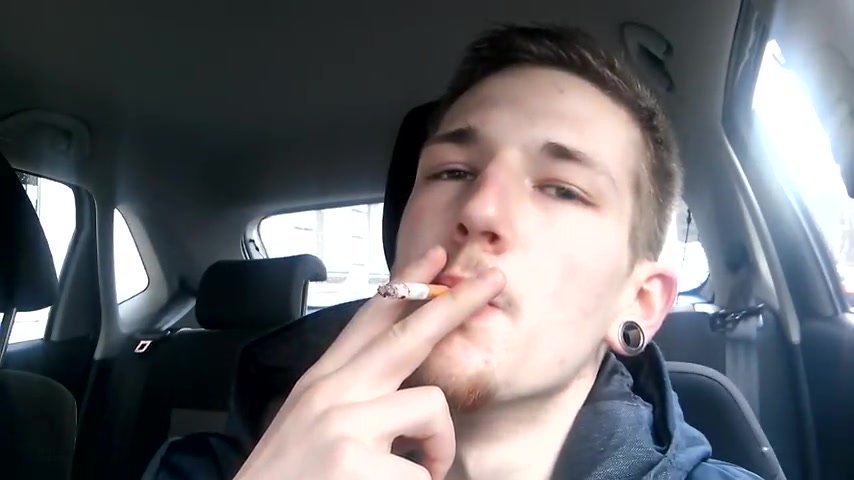 Cute lad smoking in car
